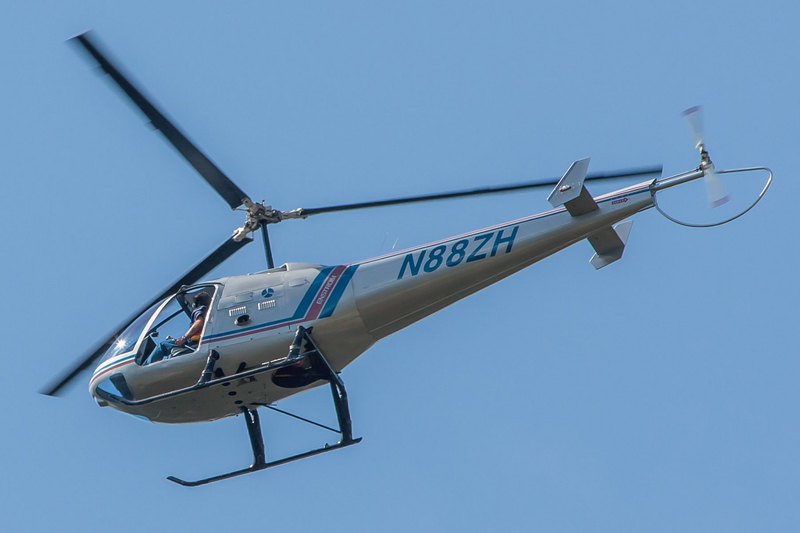 Enstrom helicopter flying high